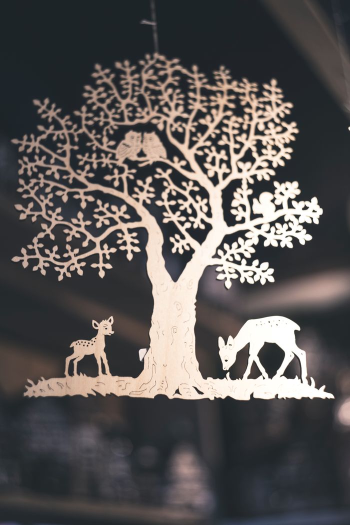 Mastering the First Impression: Your intriguing post title goes here Intricate paper cut silhouette of a tree with deer, creating a stunning artistic design.