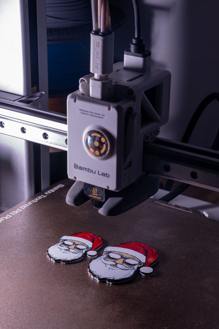 About 3D printer crafting Santa Claus figures with red hats, capturing modern holiday manufacturing.